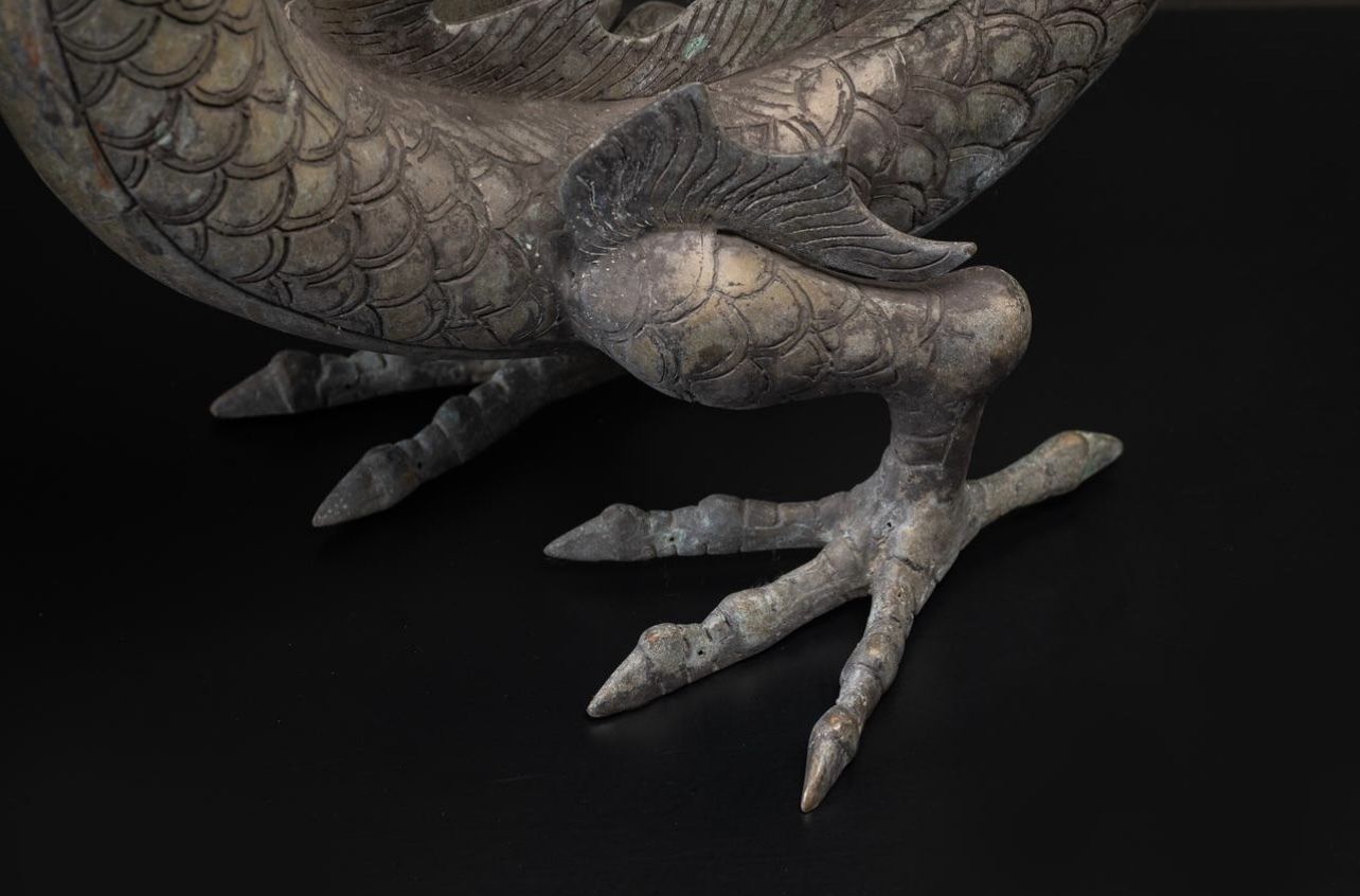 A Large Brass Dragon Chasing The Flaming Pearl Of Knowledge photo vinterior