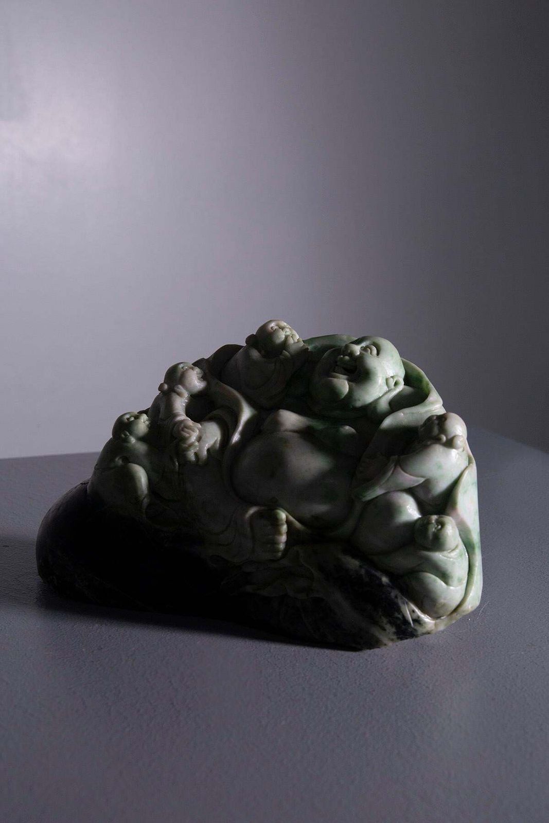 Sculpture Of Buddha Surrounded By Children In Jade Root photo Art