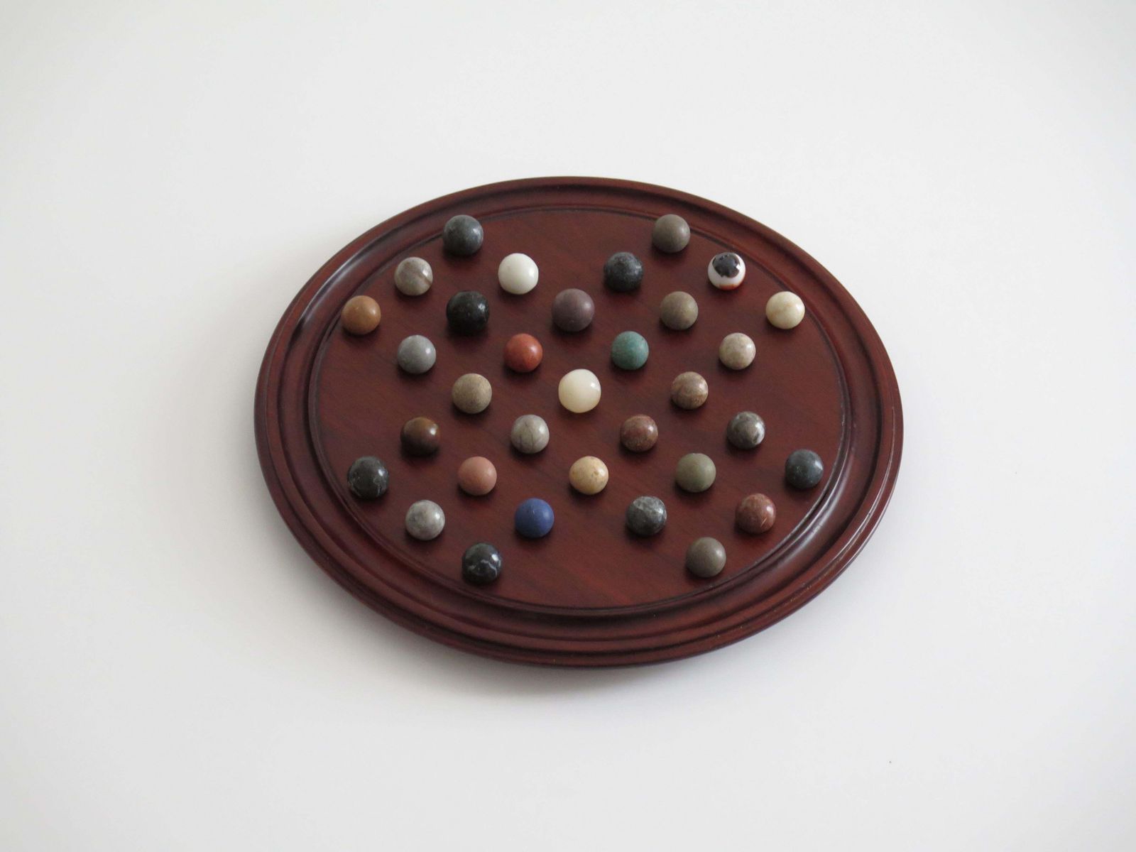 Marble Solitaire Game 10 Inch Hardwood Board 35 Mixed Stone Marbles, Circa 1945 photo for sale