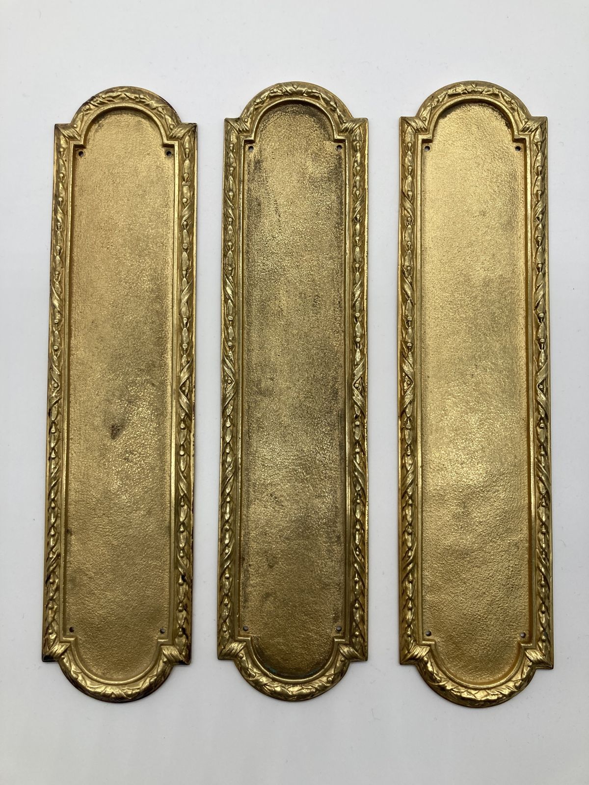 A Set Of Three Gilt Ribbon And Tie Fingerplates