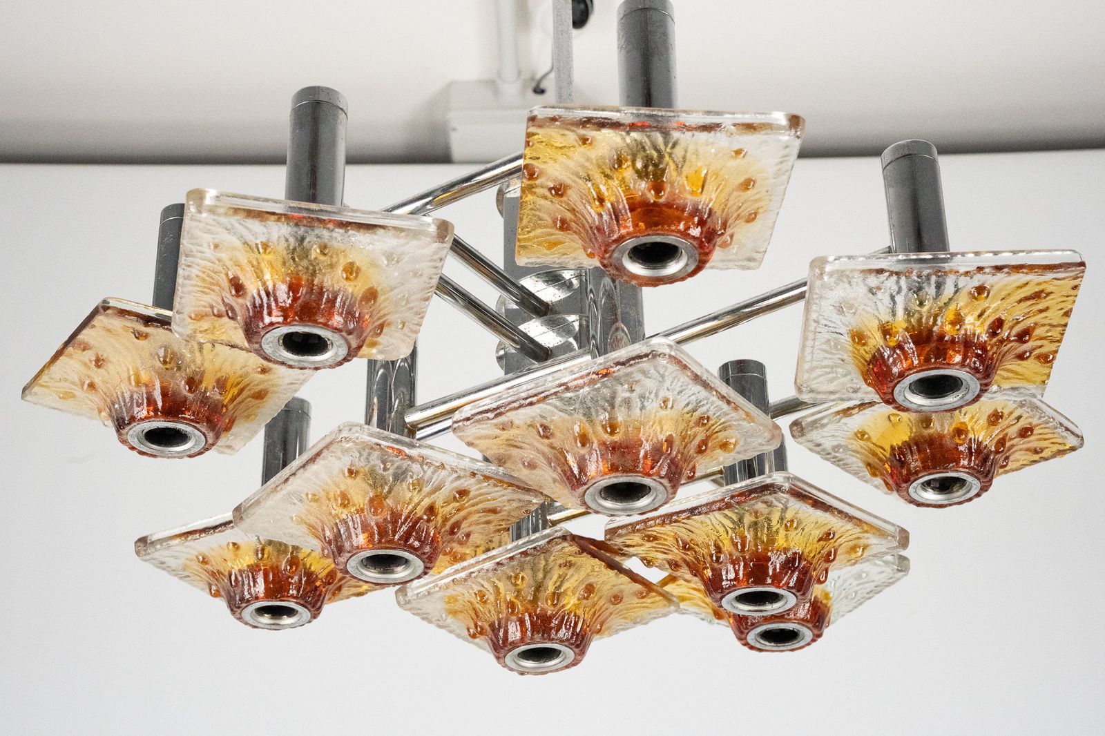 12 Light Mazzega Chandelier In Amber And Clear Murano Glass And Chrome. Italy 1970s