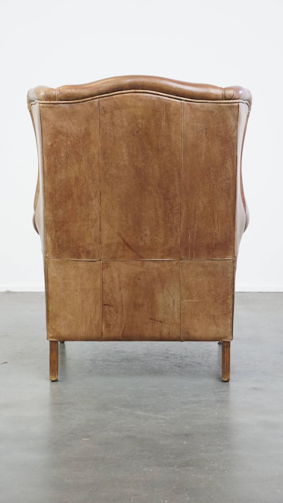 Charming, Timeless And Characterful Cowhide Wing Chair In A Light Cognac Color Finished With A Matching Piping photo Furniture