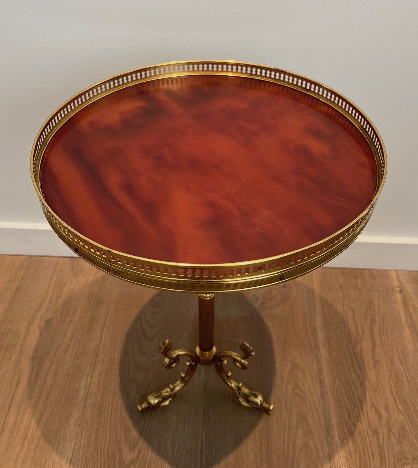 photo buy Round Neoclassical Style Brass Pedestal Table With Base Decorated With Dolphins And Red Celluloid Top Surrounded By An Openwork Gallery Attributed To