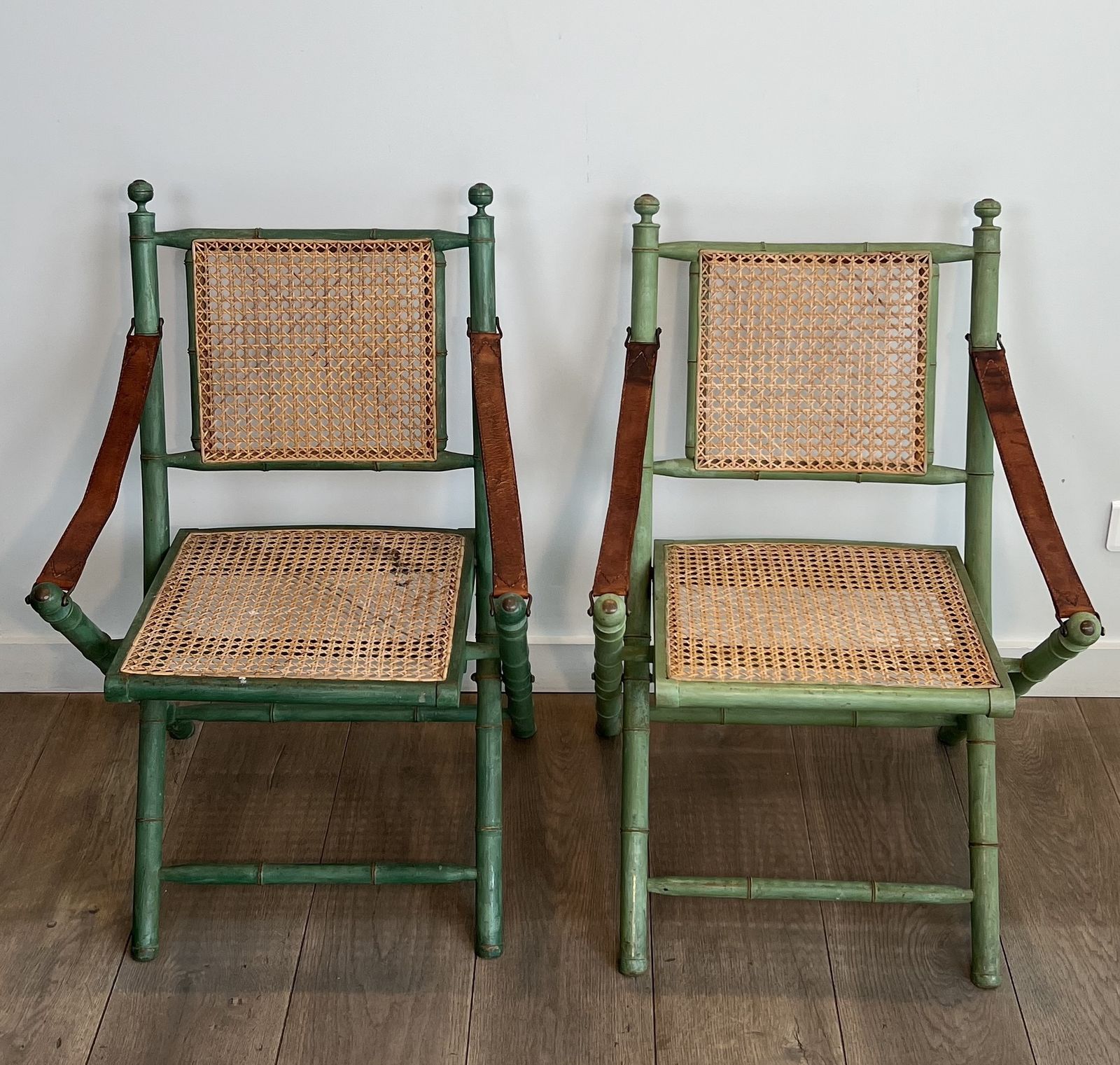 Pair Of Folding Safari Chairs In Weathered Faux Bamboo Style With Caned Backs And Seats And Leather Armrests photo furniture