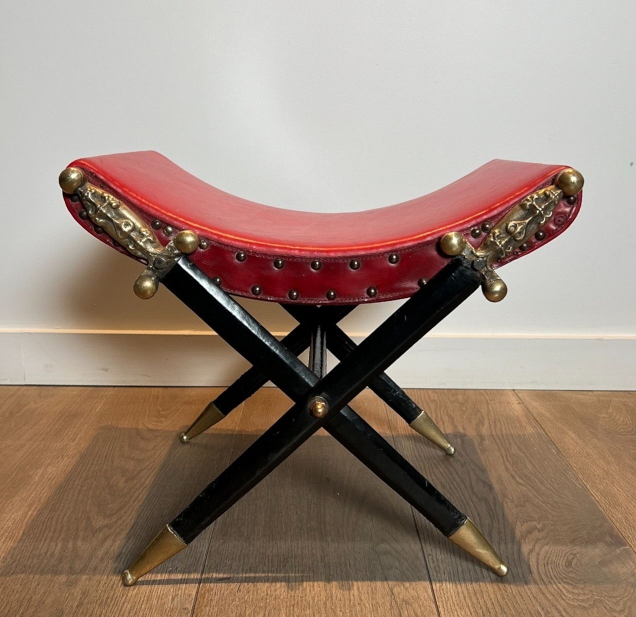 3950.0 Neoclassical Style Curule Stool In Red Leather And Decorated With Crossed Swords In Bronze And Metal Covered In Black Leather photo
