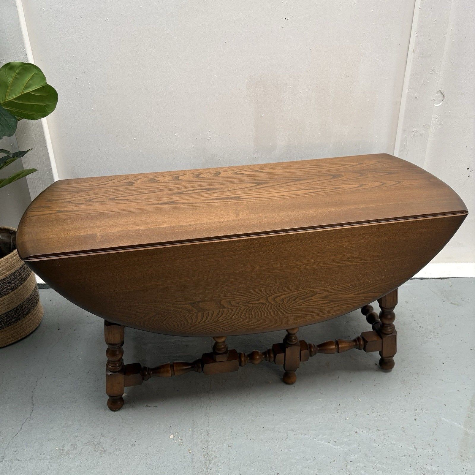 Ercol Trinity Solid Elm 2 Tier Drop Leaf Coffee Table In Golden Dawn photo furniture