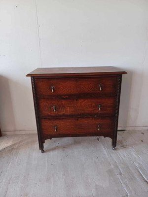 Antique Oak Chest Of Drawers On Castors With Brass Handles And Carved Details