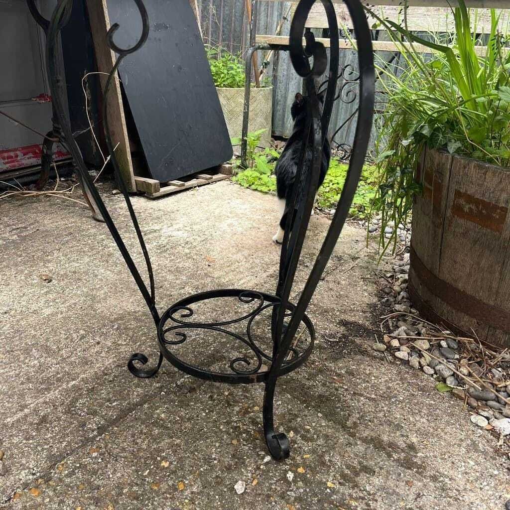 Black Metal Circular Garden Table Faded Clock Face Tripod Legs Ornate Shelf photo for sale