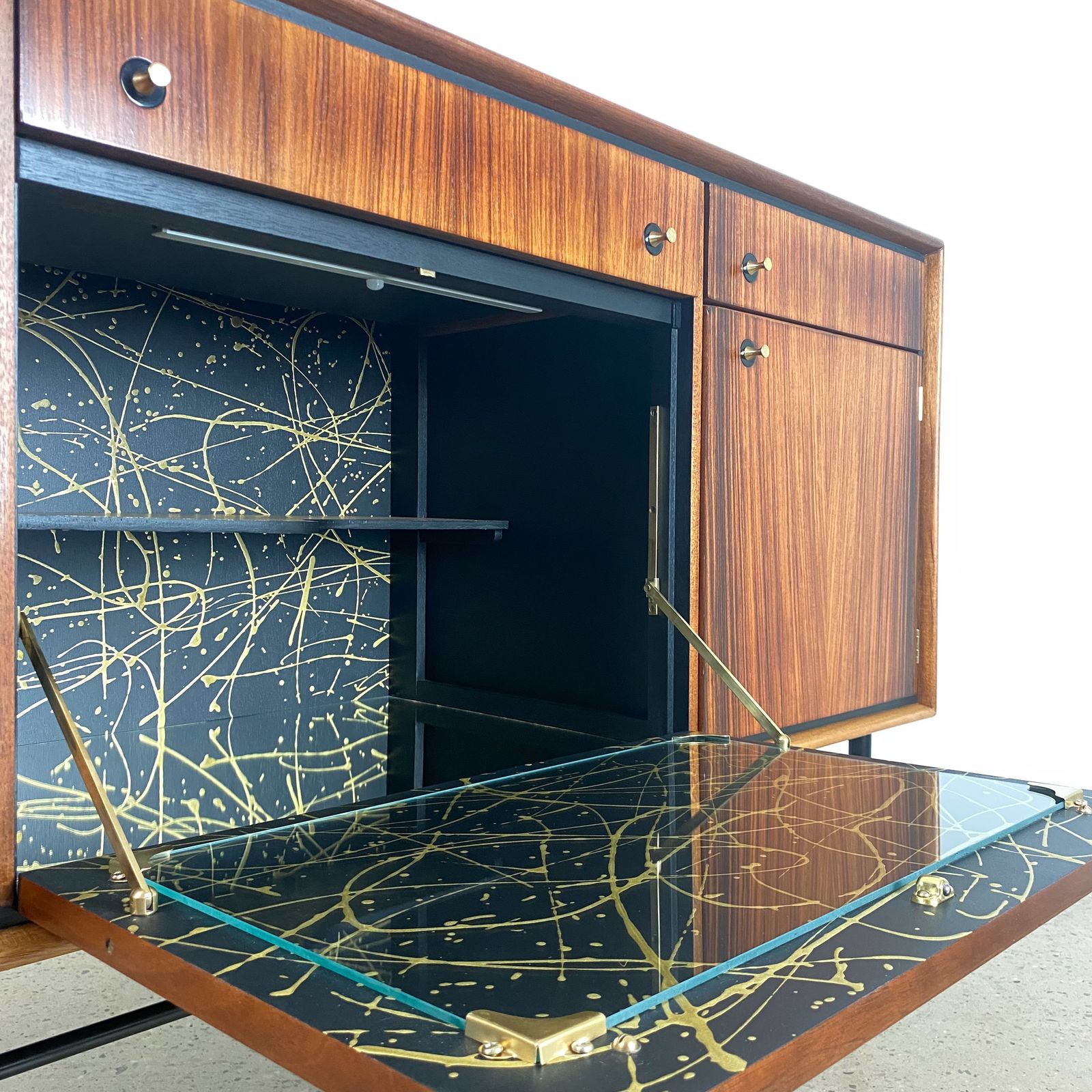photo vinterior Mid Century Cocktail Bar Drinks Cabinet By Heal's In Rosewood And Brass With Black & Gold Jackson Pollock Paint Effect