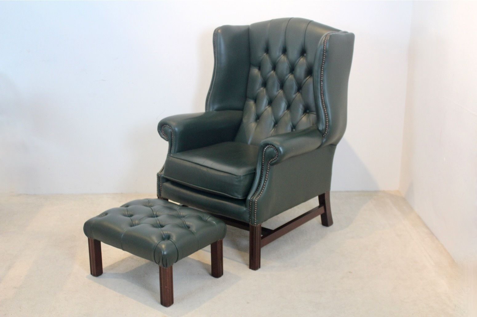 Classic Chesterfield Wingback Armchair With Footstool In Green Leather