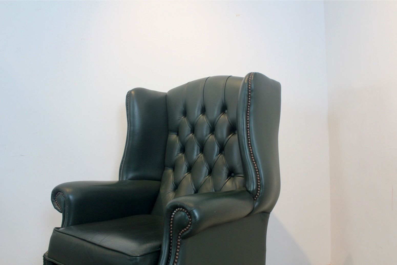 Classic Chesterfield Wingback Armchair With Footstool In Green Leather photo vinterior