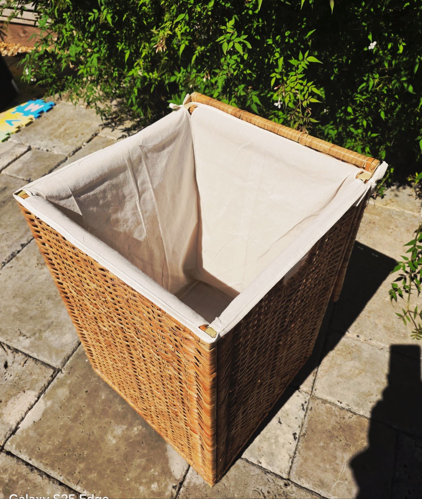 Tall Wicker Laundry Basket With Cream Linen Interior photo for sale
