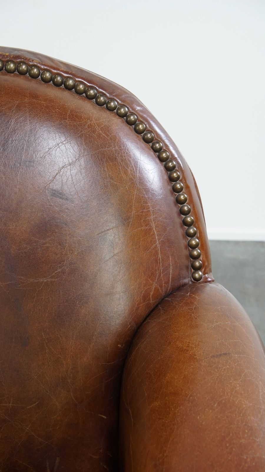 photo furniture Characterful And Timeless Cowhide Design Armchair With Beautiful Round Shapes And Decorative Nails