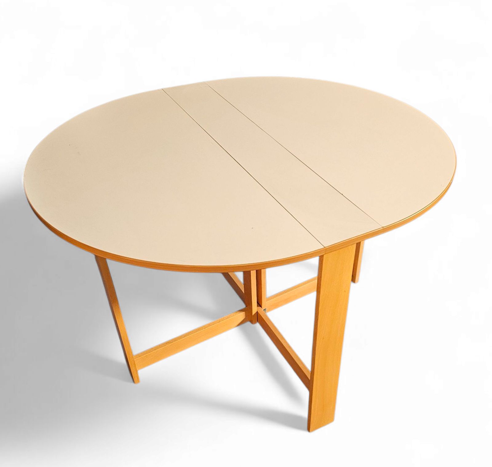 Vintage Scandinavian Folding Dining Table With Side Leaves. The Oval Top Is Made Of White Formica