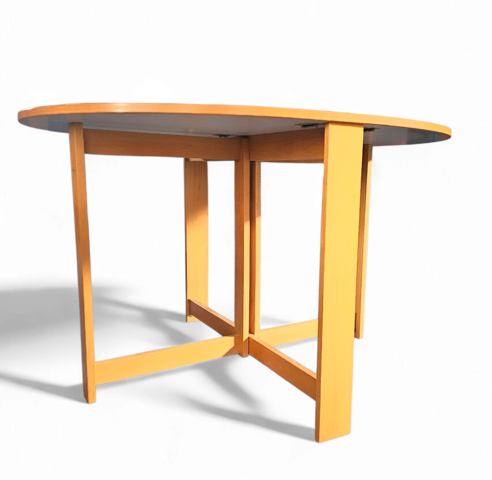 photo vintage Vintage Scandinavian Folding Dining Table With Side Leaves. The Oval Top Is Made Of White Formica