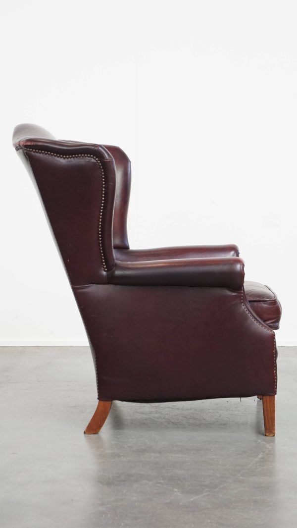 Charming And Comfortable Burgundy Red Cowhide Wing Chair In English Style With A Beautiful Patina photo for sale