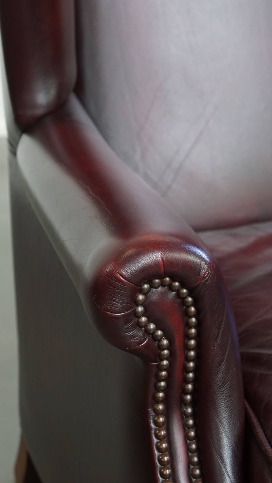 photo for sale Beautiful And Comfortable Burgundy Red Cowhide Wing Chair In English Style With A Wonderful Patina