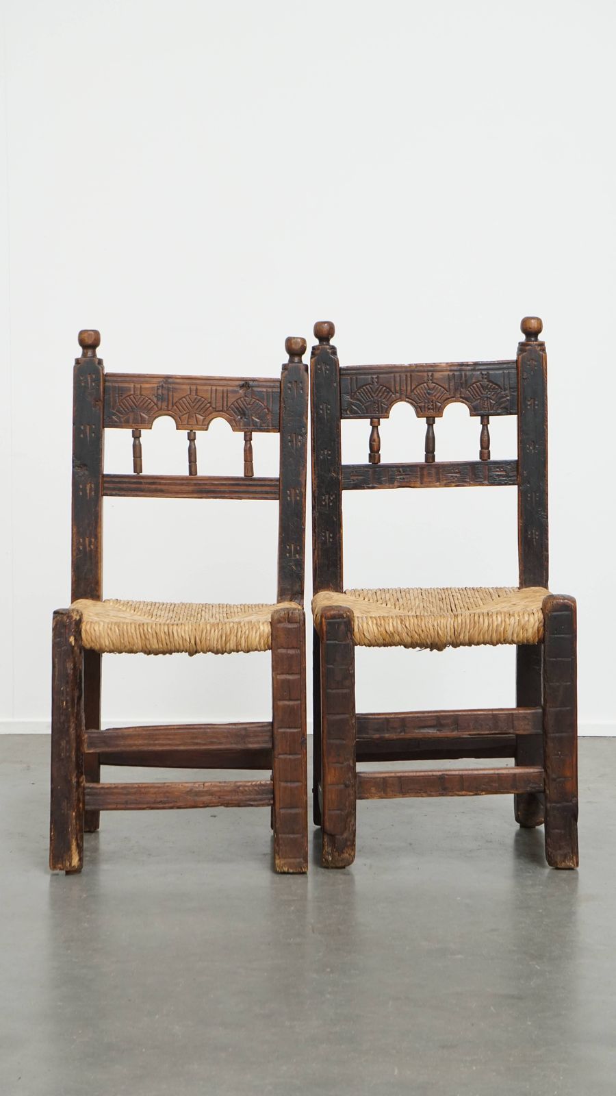Unique Set Of 4 Antique Spanish Farm Chairs With Woven Wicker Seats And Beautiful Wood Carvings photo for sale