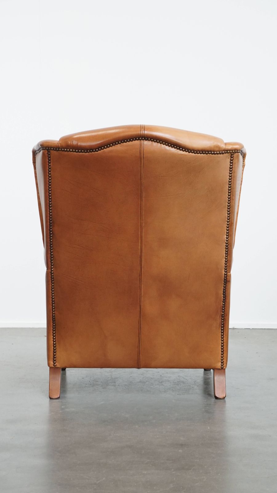 Classic And Unique Cowhide Wing Chair Finished With Decorative Nails And Beautiful Details photo Furniture