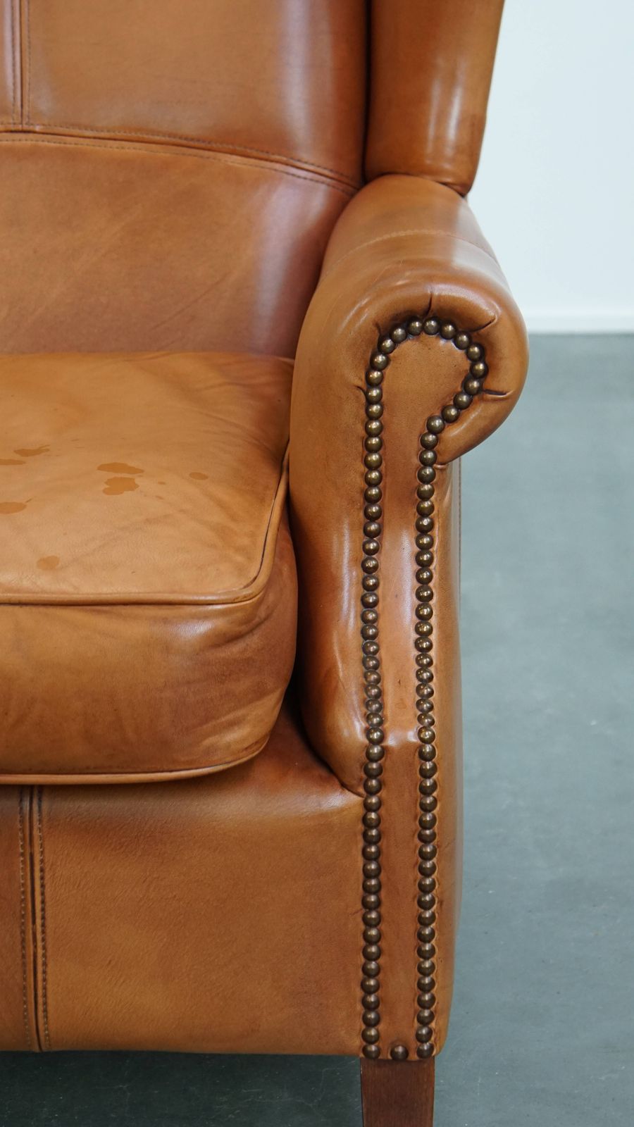 photo furniture Classic And Unique Cowhide Wing Chair Finished With Decorative Nails And Beautiful Details