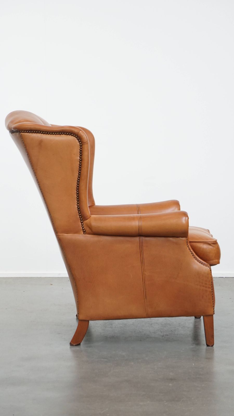 Unique And Comfortable Wing Chair Made Of Cowhide Leather Finished With Decorative Studs And Beautiful Details photo for sale