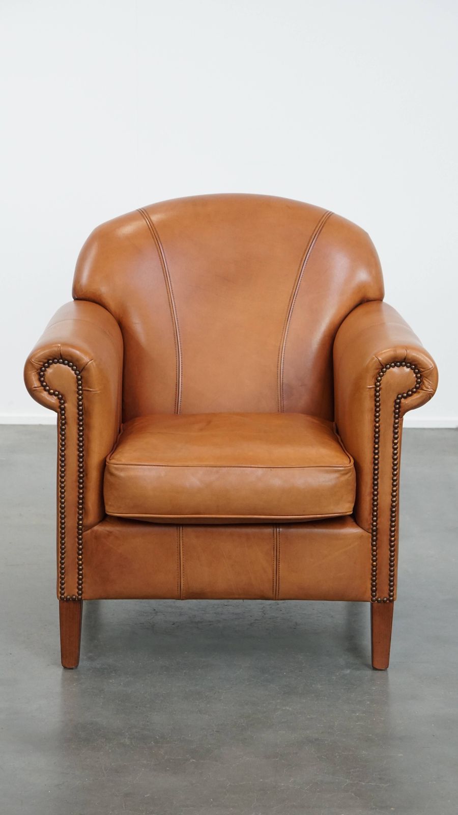 Beautiful And Comfortable Cowhide Leather Armchair In A Warm Cognac Color Finished With Decorative Nails photo furniture