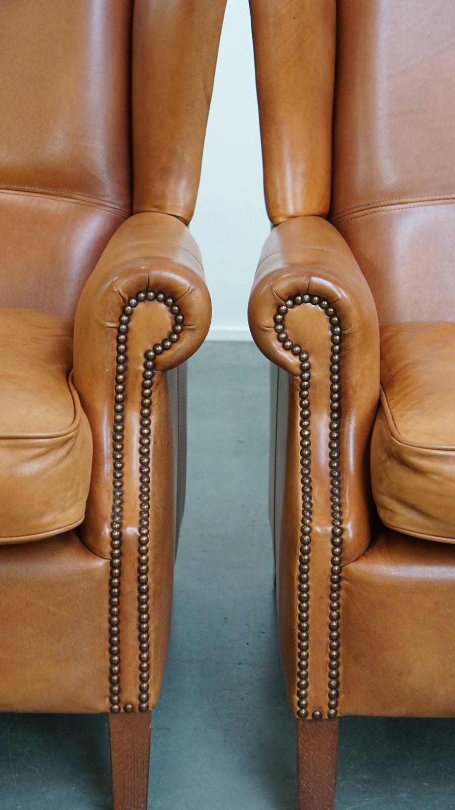 photo for sale Classic And Unique Set Of 2 Cowhide Wing Chairs Finished With Decorative Nails And Beautiful Details