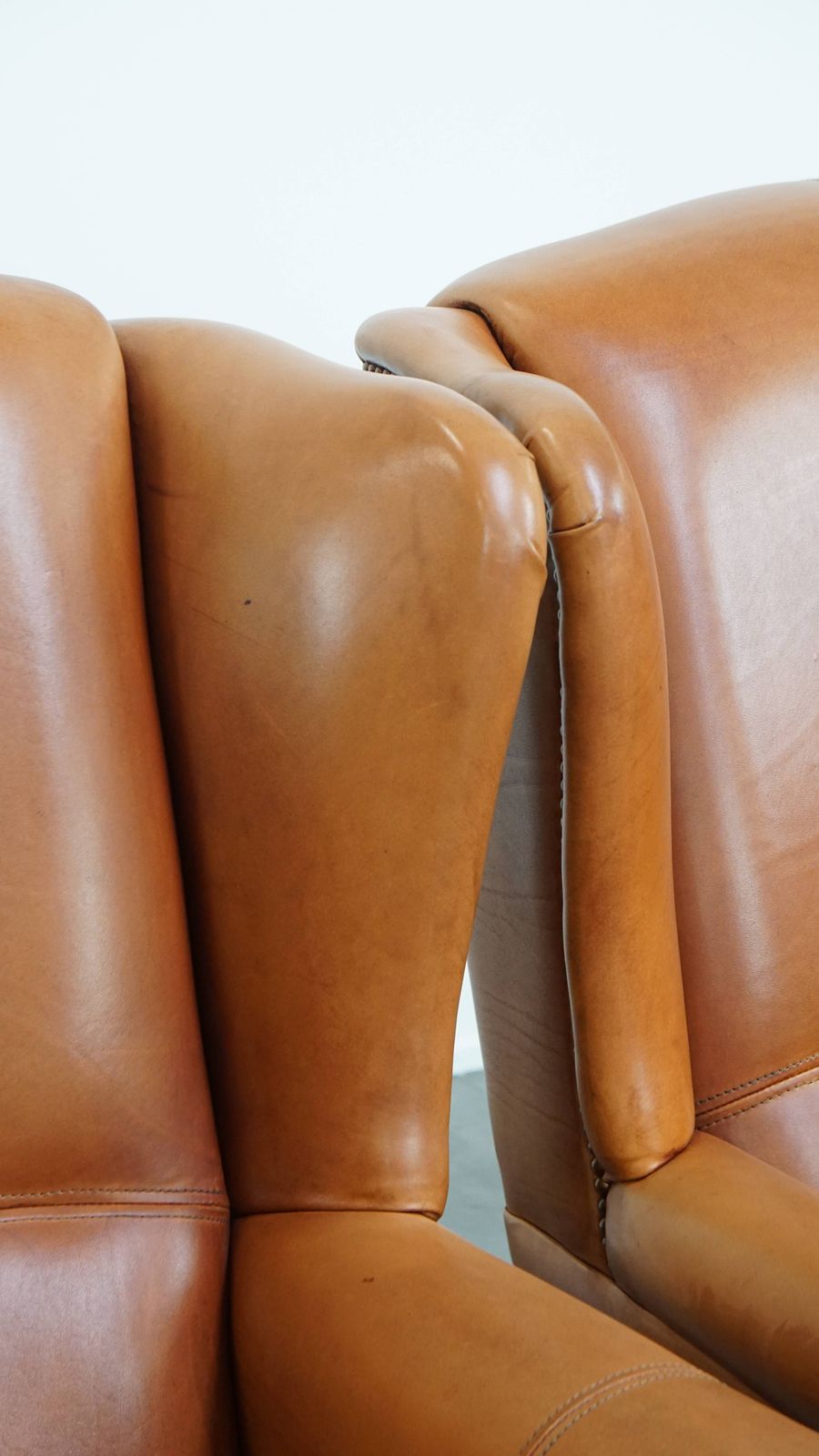 photo buy Classic And Unique Set Of 2 Cowhide Wing Chairs Finished With Decorative Nails And Beautiful Details