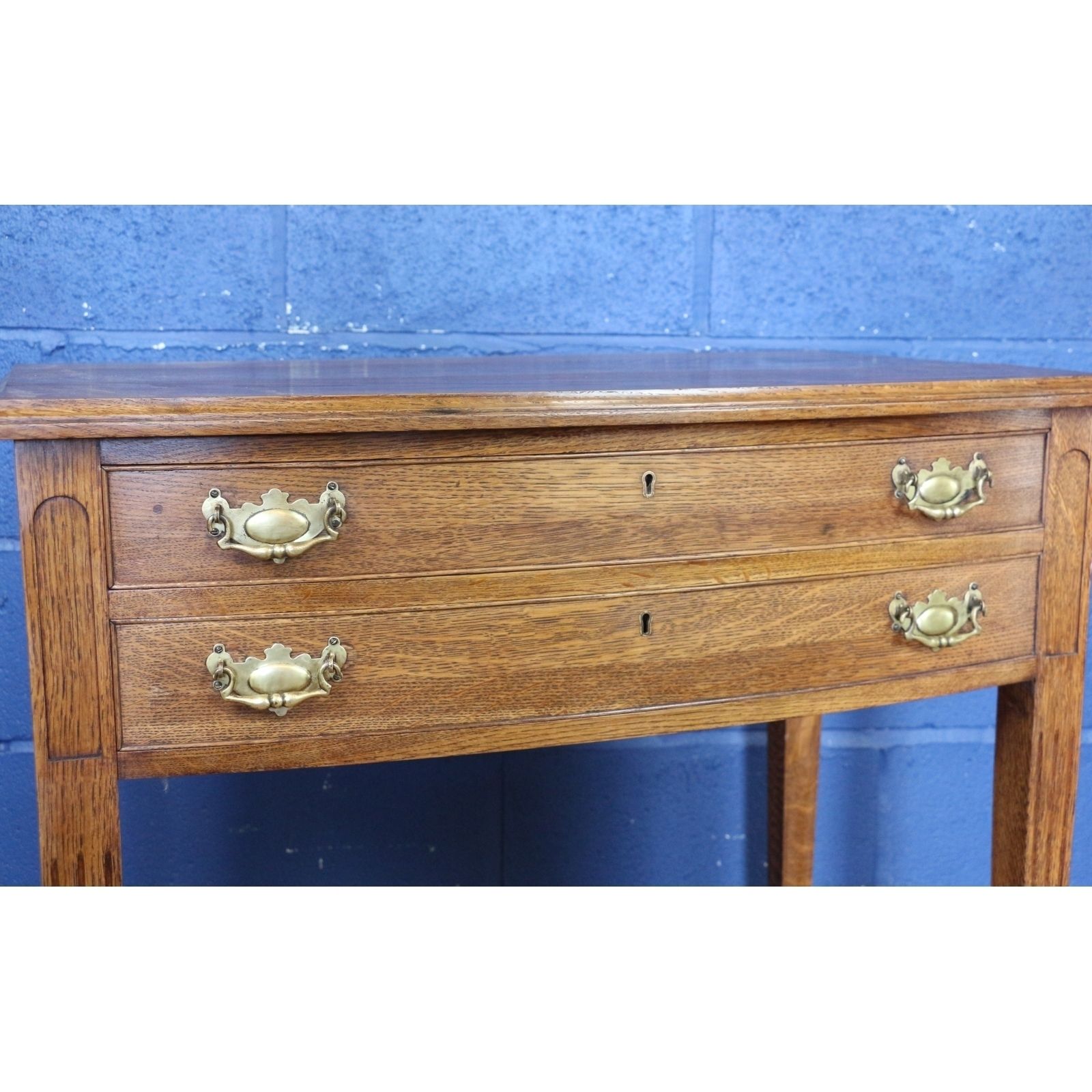 A Quality Oak Bow Fronted Two Drawer Side Table Raised On Tapering Spade Feet photo buy