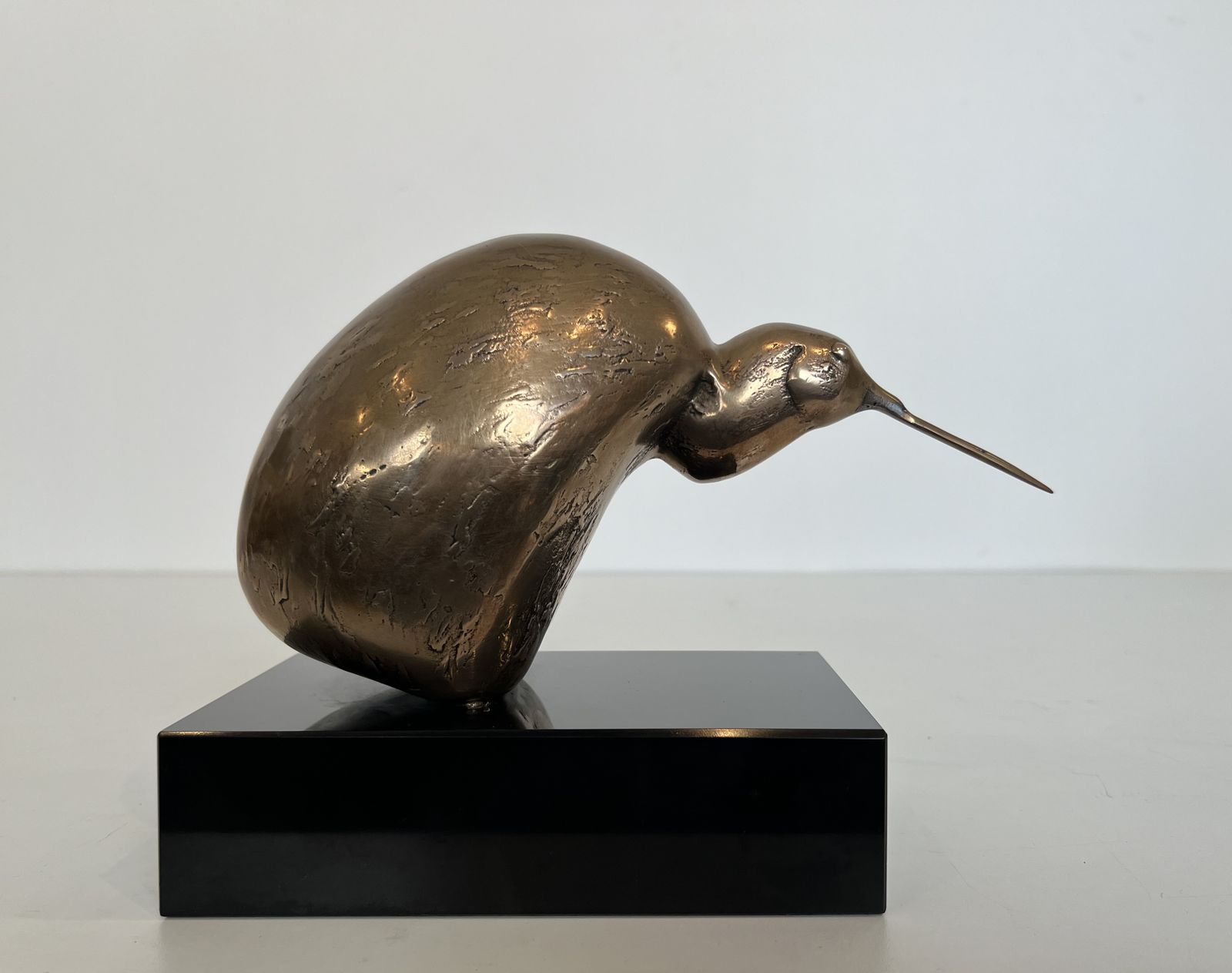Bronze Sculpture Representing A Stylized Bird On A Black Marble Base, Signed And Numbered