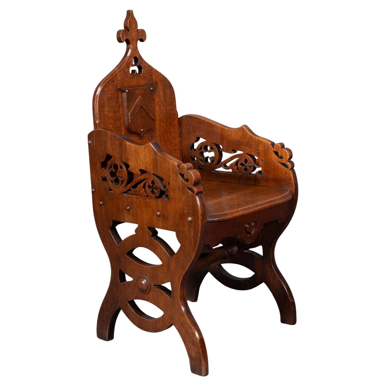 A High Gothic Revival Oak Armchair With Carved And Fretwork Sides