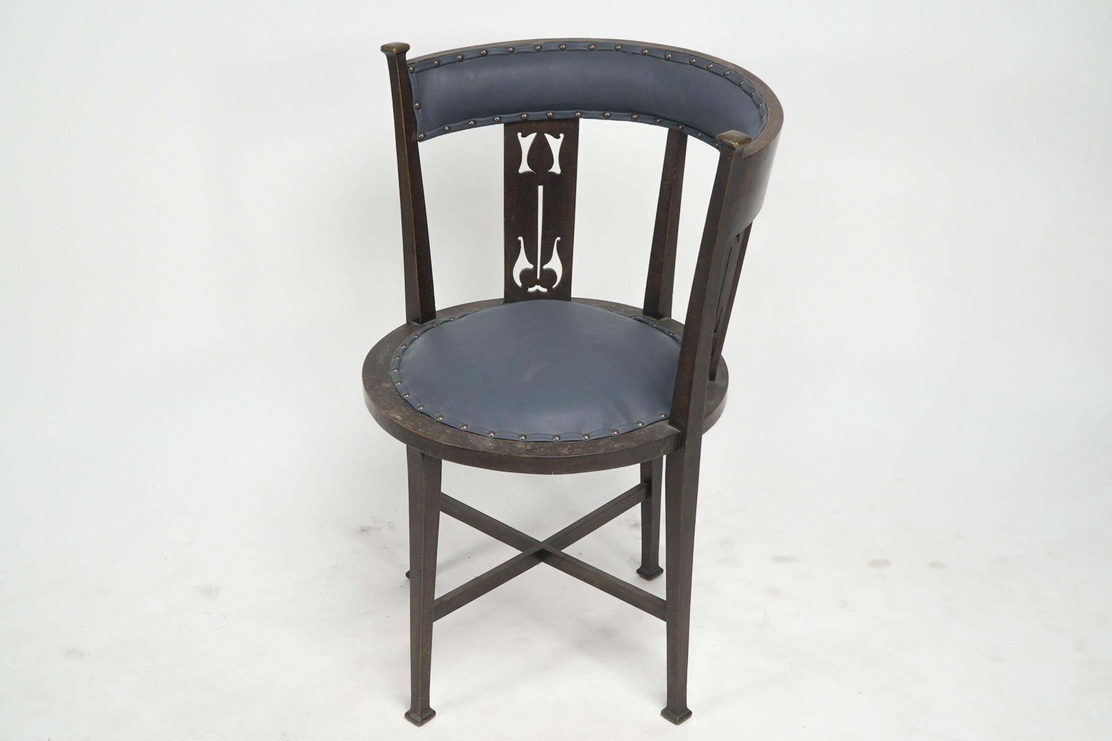 An Arts And Crafts Mahogany Tub Chair With Stylized Floral Cut Outs photo furniture
