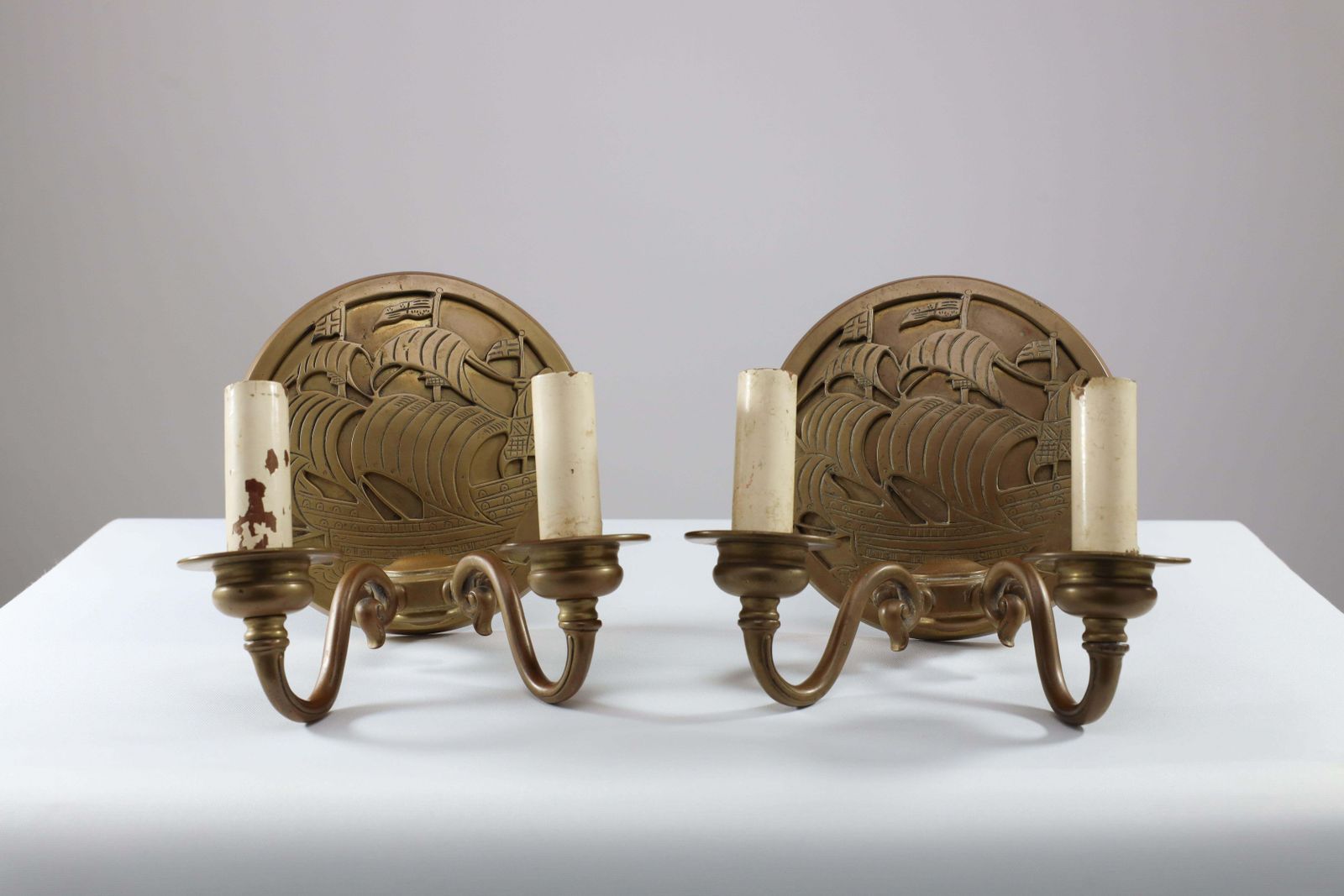 A Pair Of Arts And Crafts Brass Wall Lights With Galleons In Sail. photo furniture