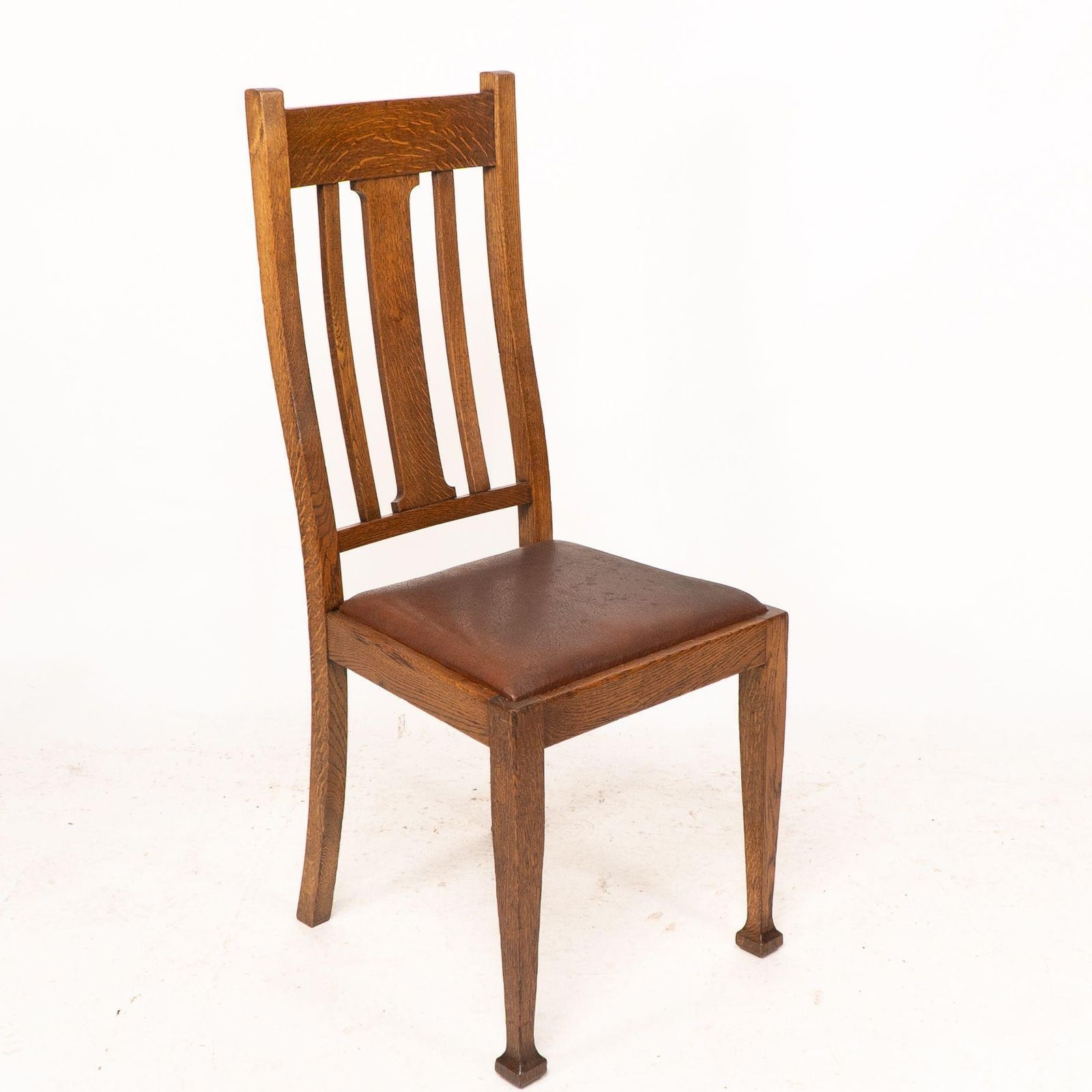 A Set Of Four Arts And Crafts Oak Dining Chairs With Comfortable Shaped Backs photo furniture