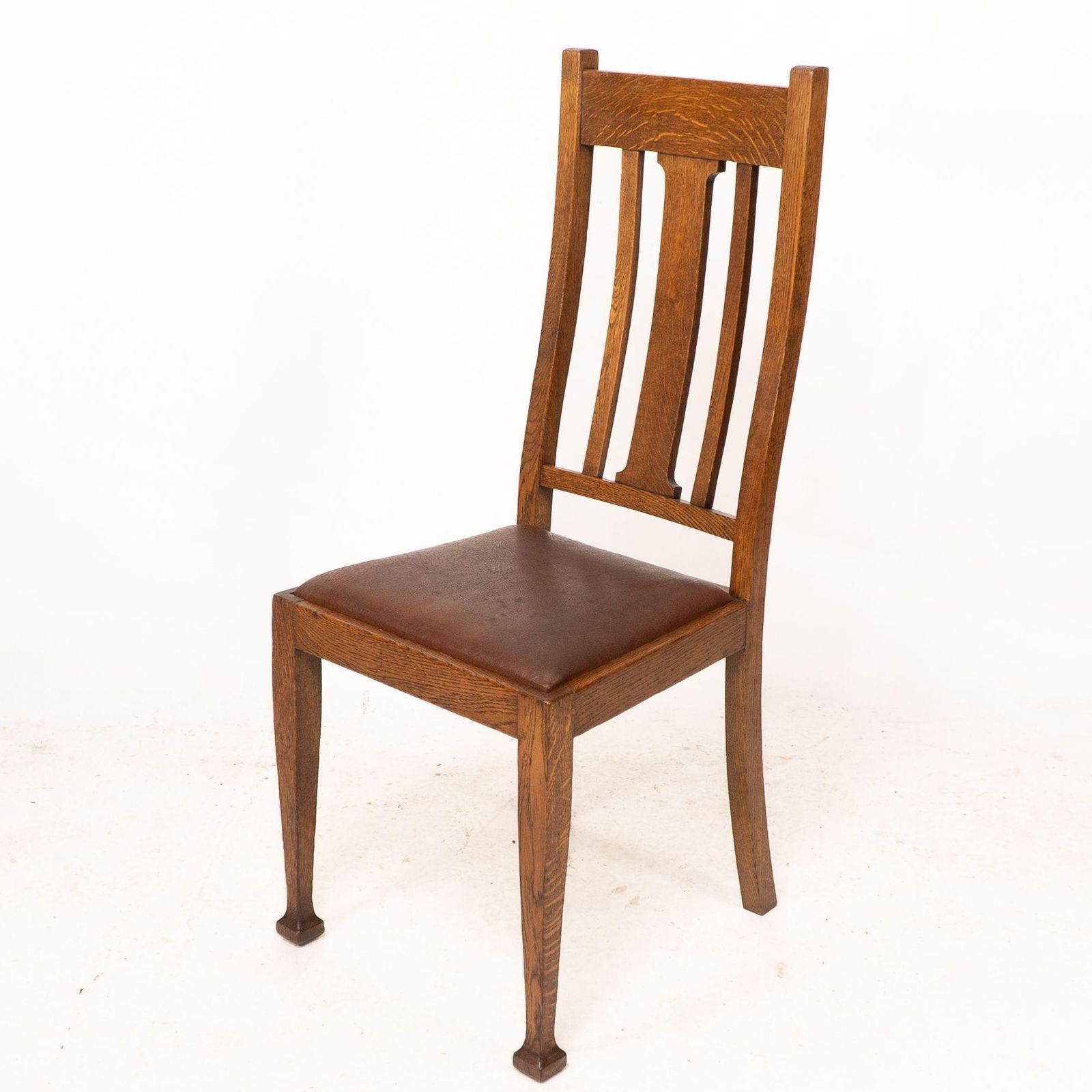A Set Of Four Arts And Crafts Oak Dining Chairs With Comfortable Shaped Backs photo Furniture