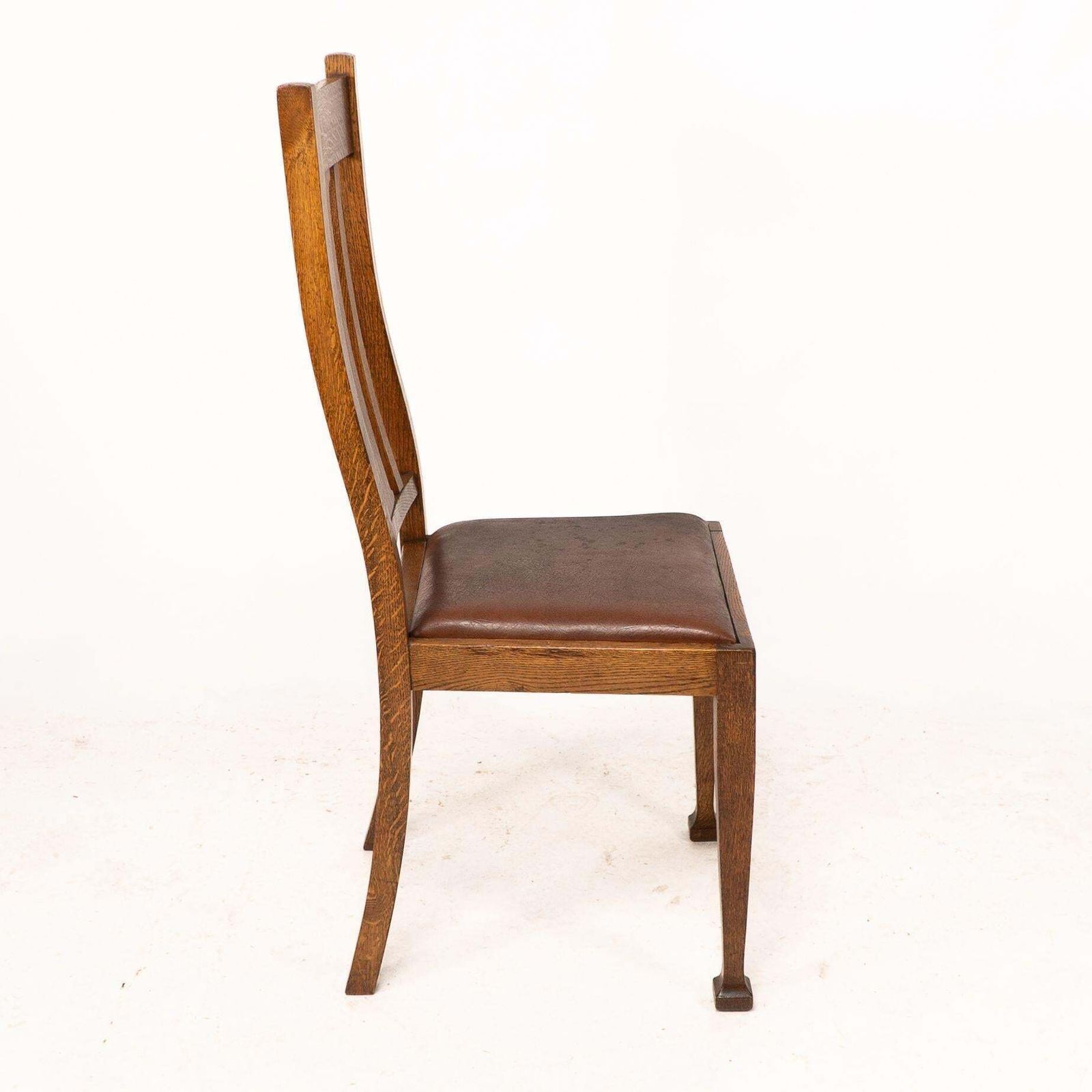 A Set Of Four Arts And Crafts Oak Dining Chairs With Comfortable Shaped Backs photo 1843.0