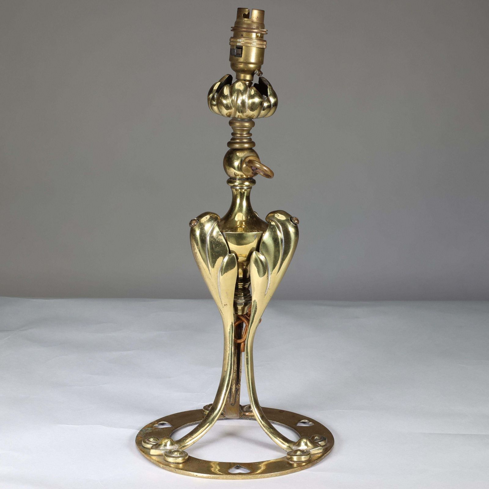 An Arts & Crafts Brass Table Lamp Tulip Shaped With Heart Cut Outs To The Base photo furniture