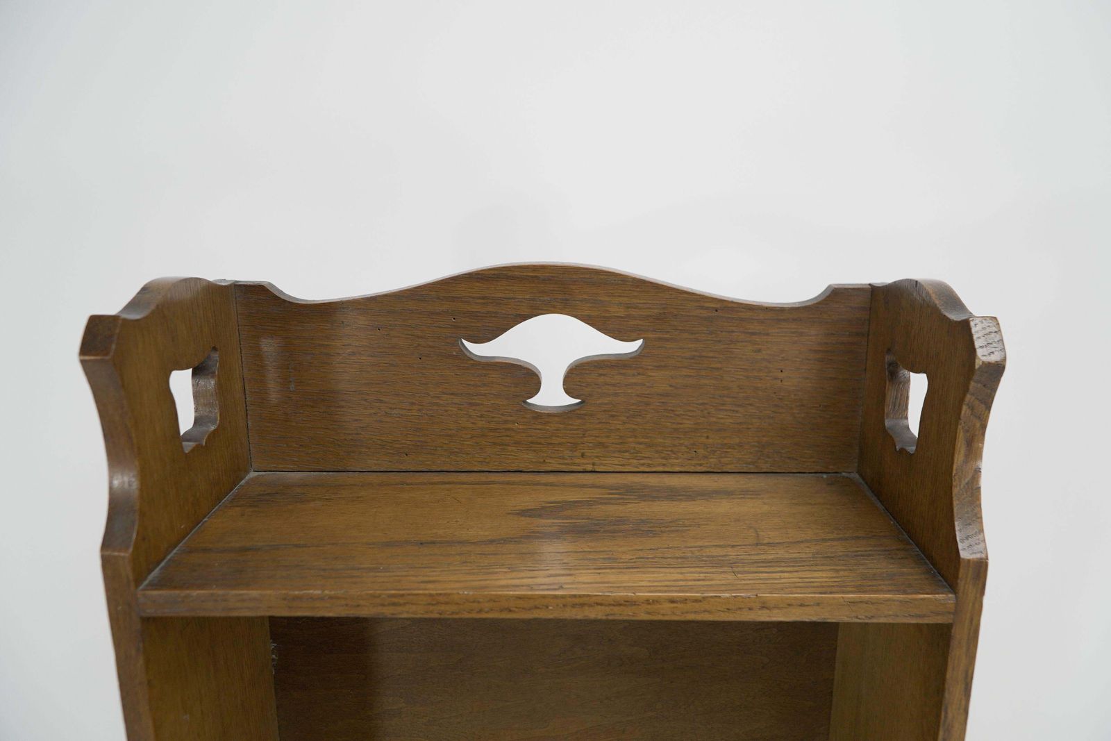 Liberty & Co. A Slim Arts And Crafts Oak Bookcase With Stylized Floral Cut Outs photo for sale
