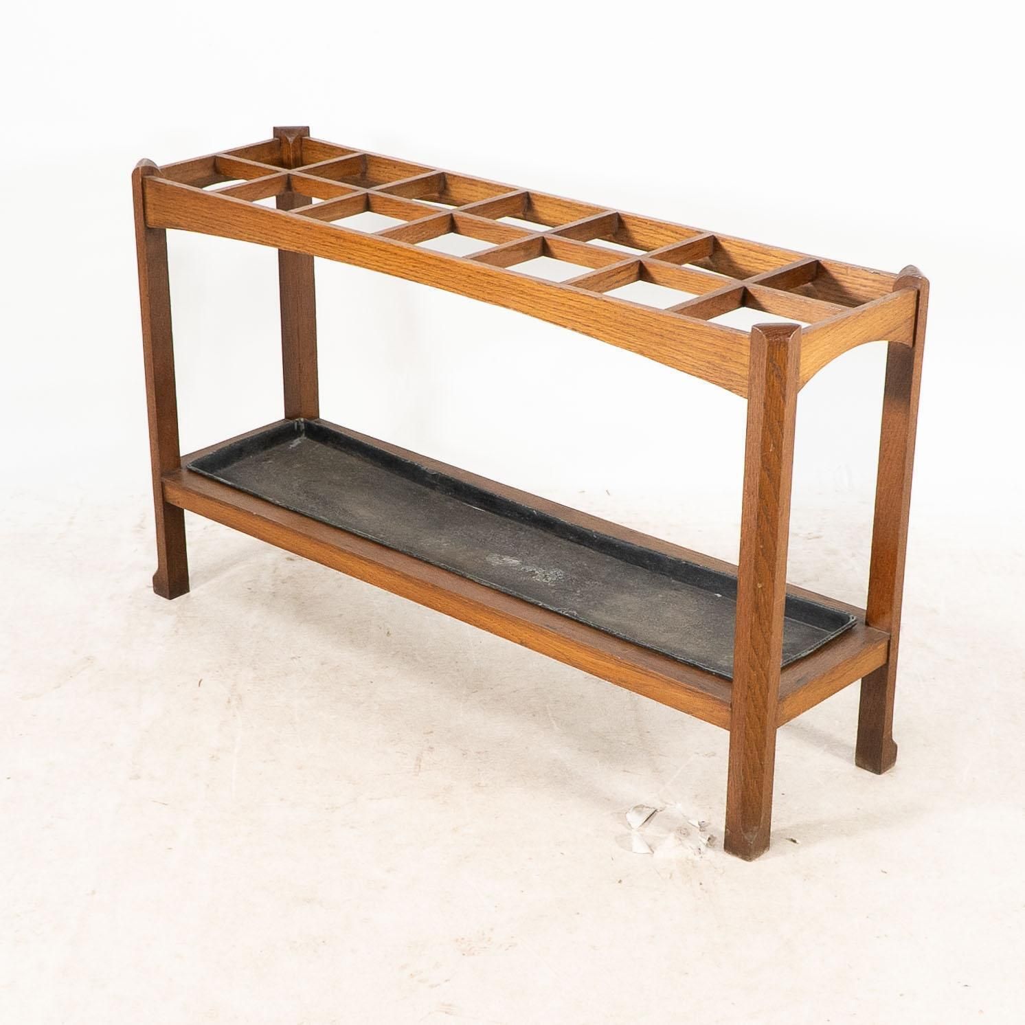 An Arts And Crafts Oak Stick And Umbrella Stand With Fourteen Sections photo for sale