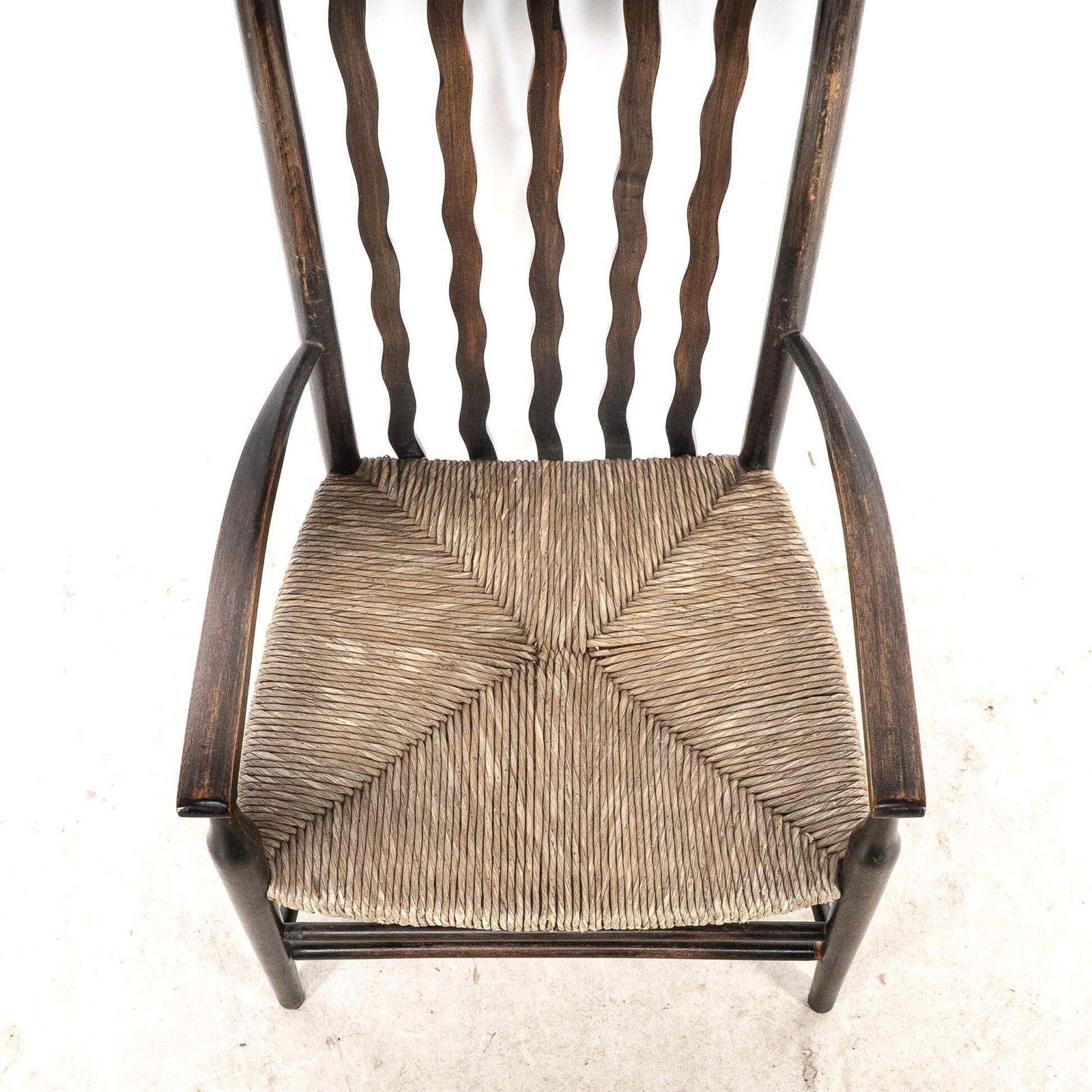 photo furniture Liberty & Co. An Arts & Crafts Rush Seat Armchair With Wavy Shaped Back Slats