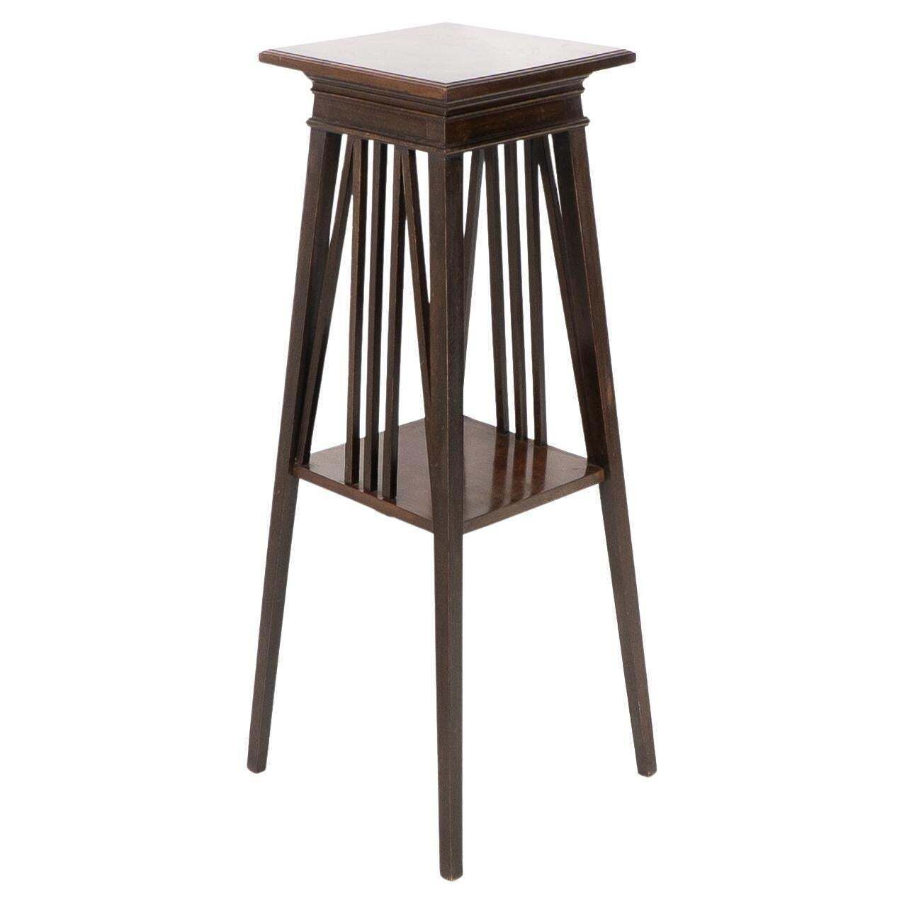 Liberty & Co In The Style Of E W Godwin. An Anglo Japanese Two Tier Plant Stand