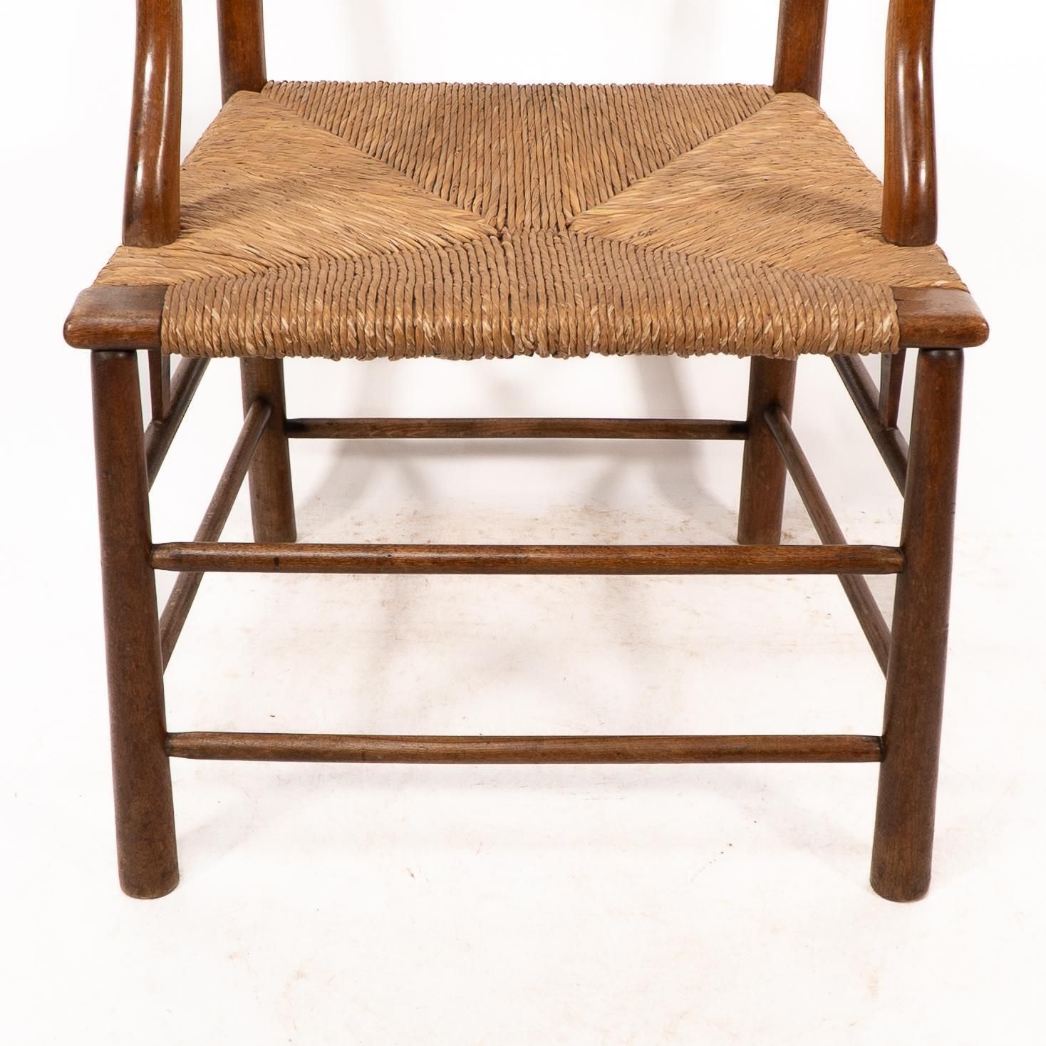C R Ashbee. An Arts And Crafts Rush Seat Ladder Back Armchair photo buy