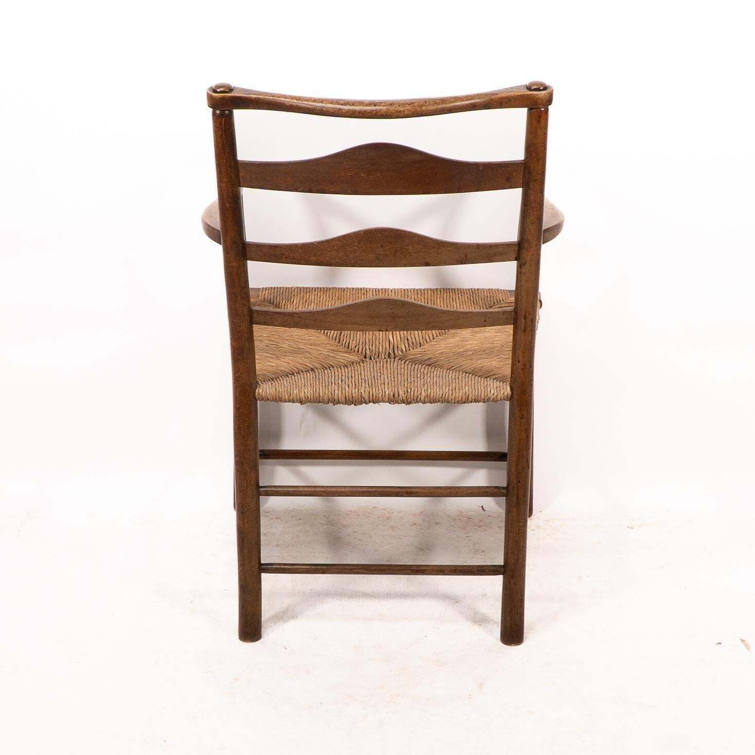 photo vintage C R Ashbee. An Arts And Crafts Rush Seat Ladder Back Armchair