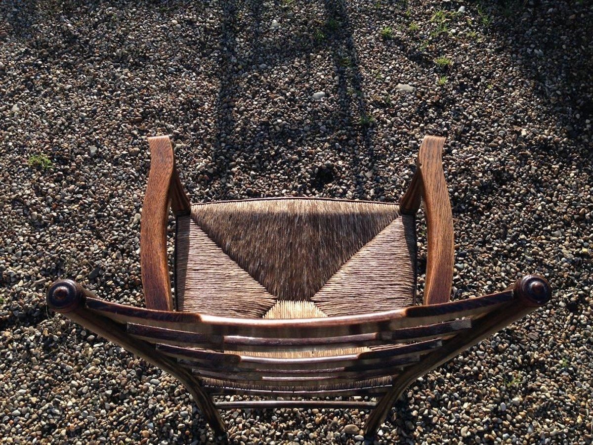 An English Cotswold School Oak Ladder Back Rush Seat Armchair photo for sale