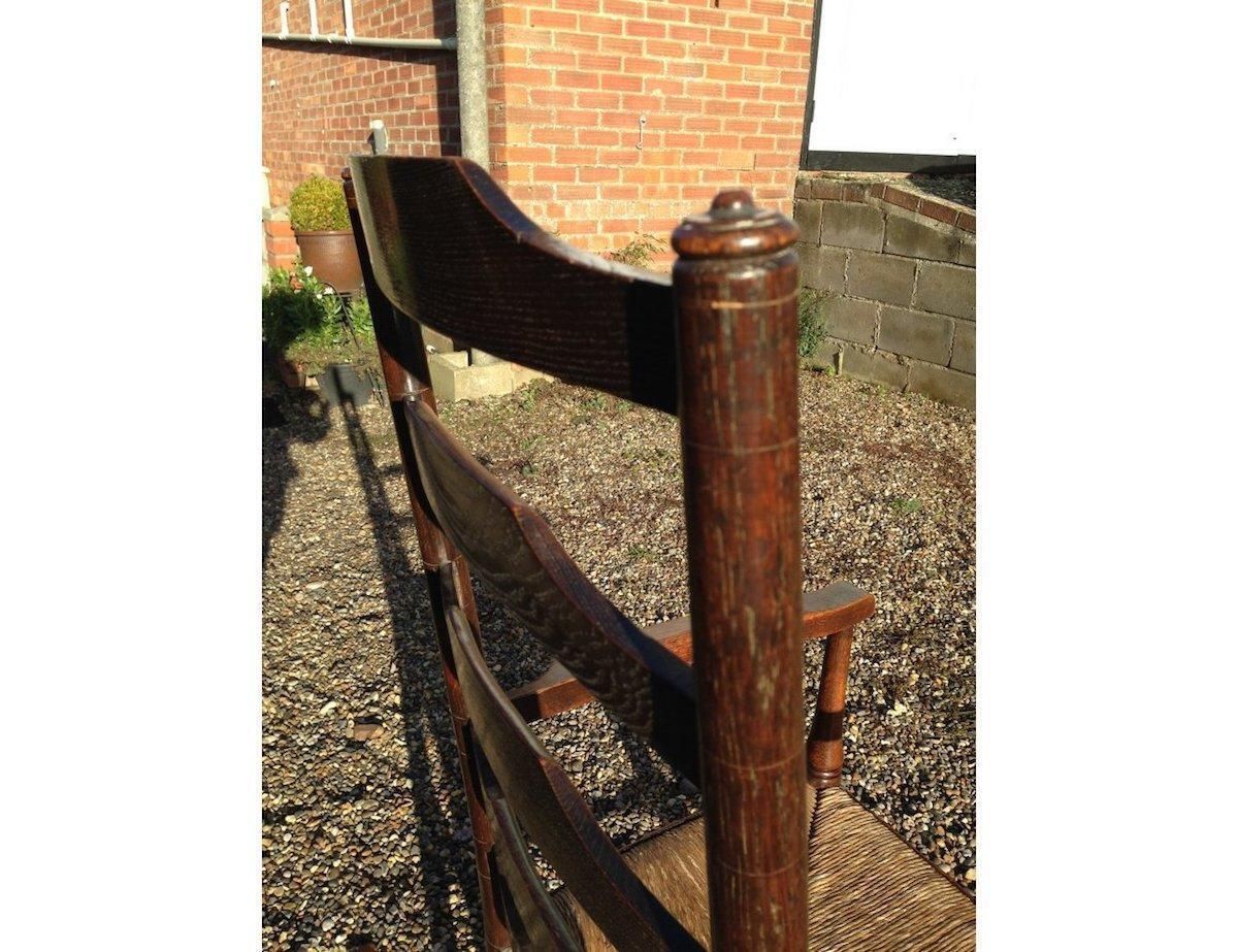 An English Cotswold School Oak Ladder Back Rush Seat Armchair photo 1400.0