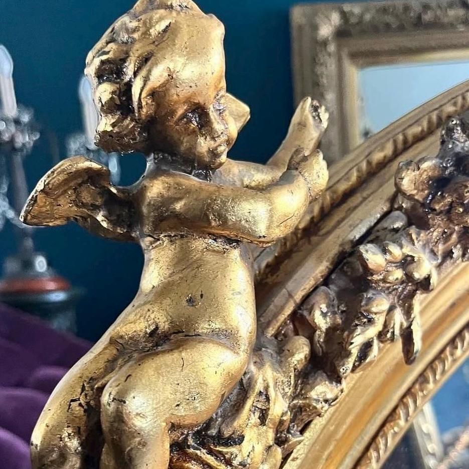 Beautiful French Oval Shaped Highly Carved Mirror With Cherubs, Floral Foilage photo for sale