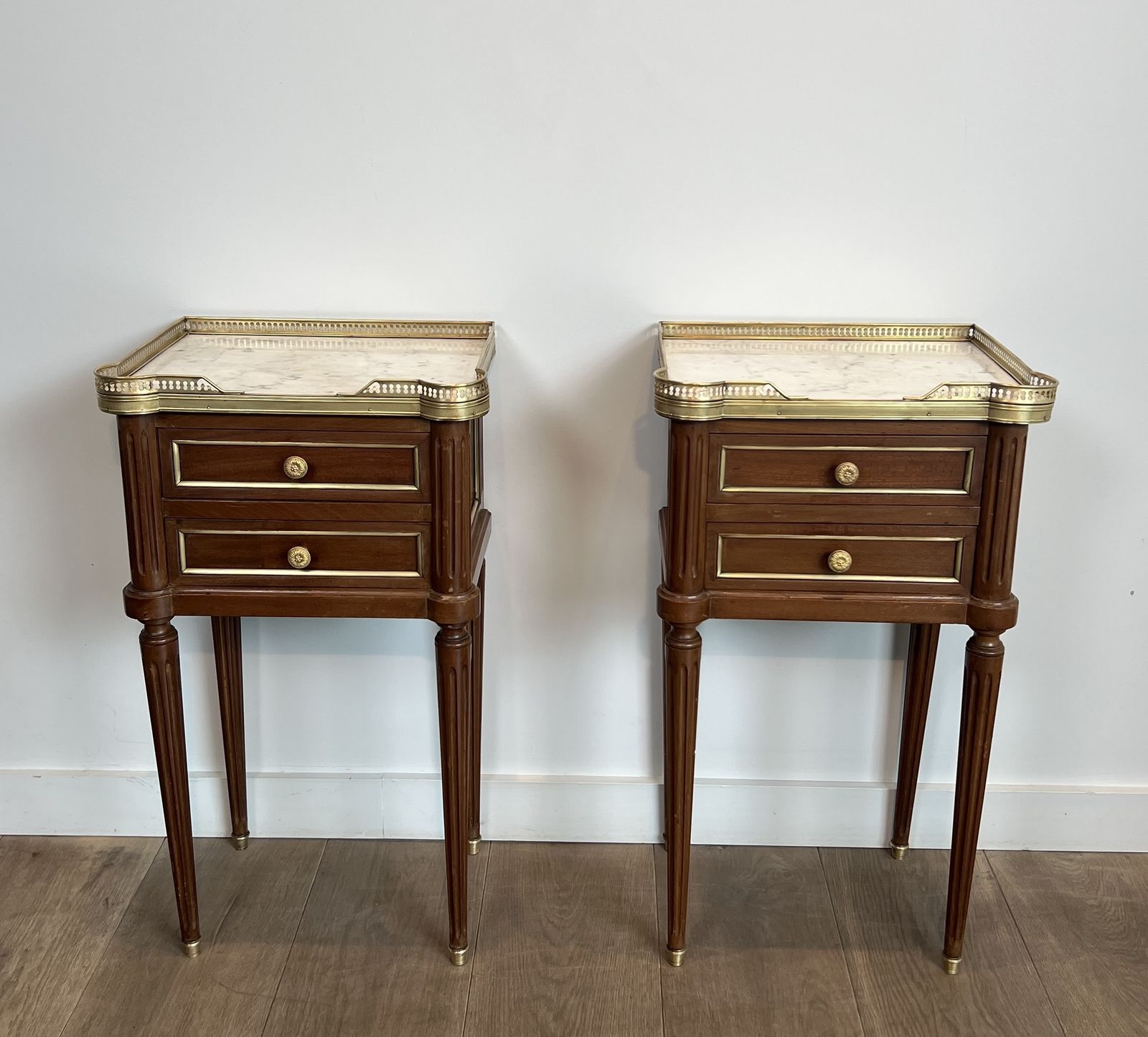 Pair Of Mahogany And Brass End Tables Or Bedside Tables With Carrara Marble Tops In The Style Of Maison Jansen. Circa 1940