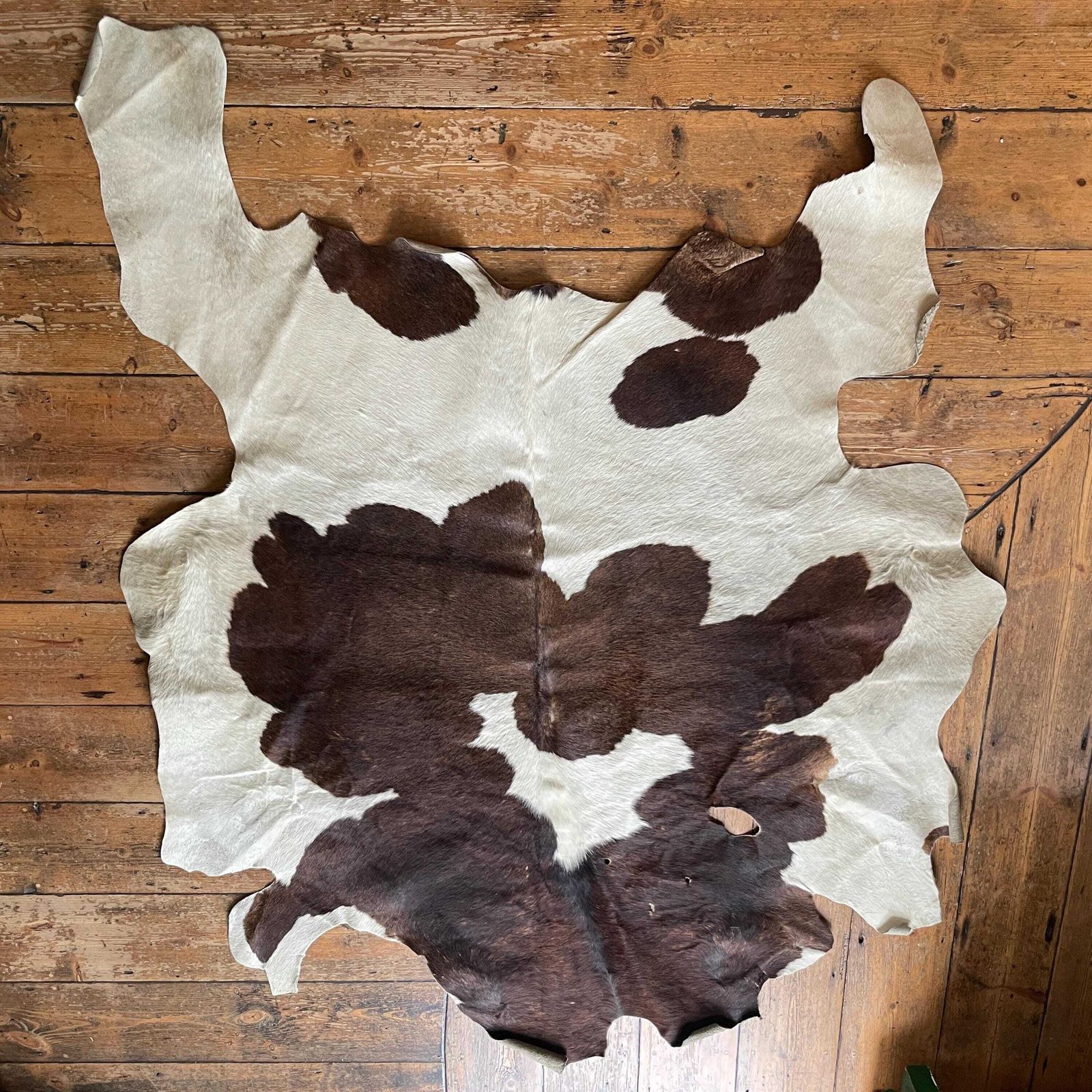 Natural Brown White Cowhide Rug Genuine Leather Unusual Shape Farmhouse Rustic Boho Western Style Floor Mat Large Hide Home Accent photo for sale