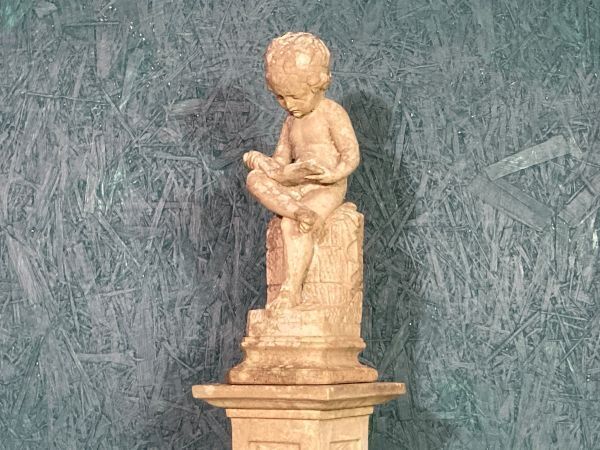 A Fine Petite Stoneware Sculpture Of A Seated Cherub photo furniture