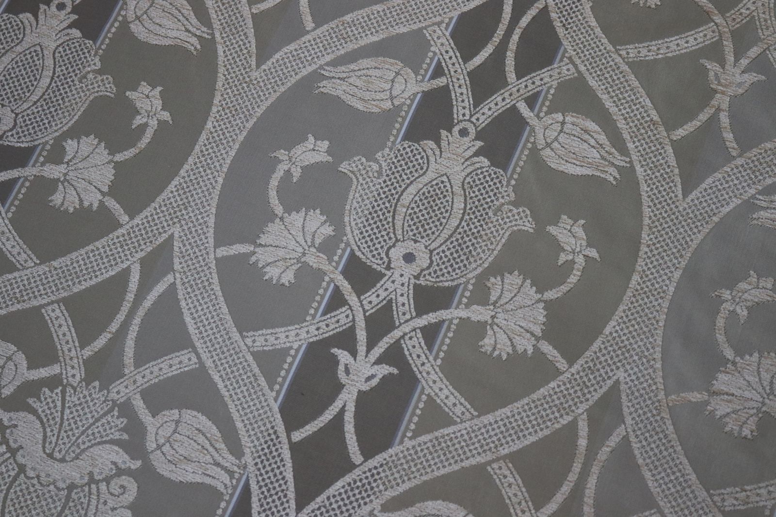 Roll Of Gold Fabric With A Decorative Design photo Textiles